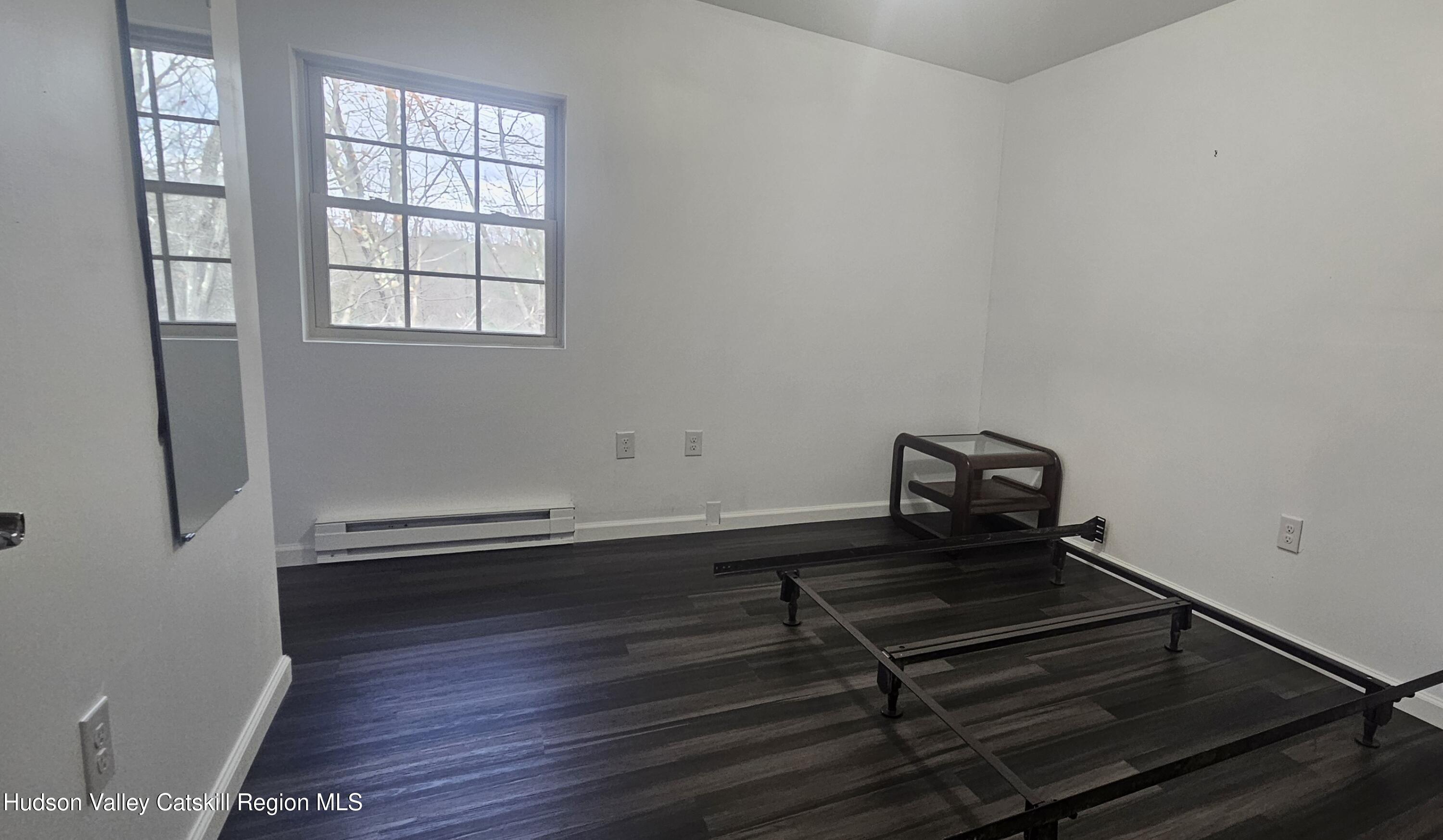 374 North Ridge Road Hannacroix, NY 12087 - Photo 12 of 24 a room with wooden floor and windows