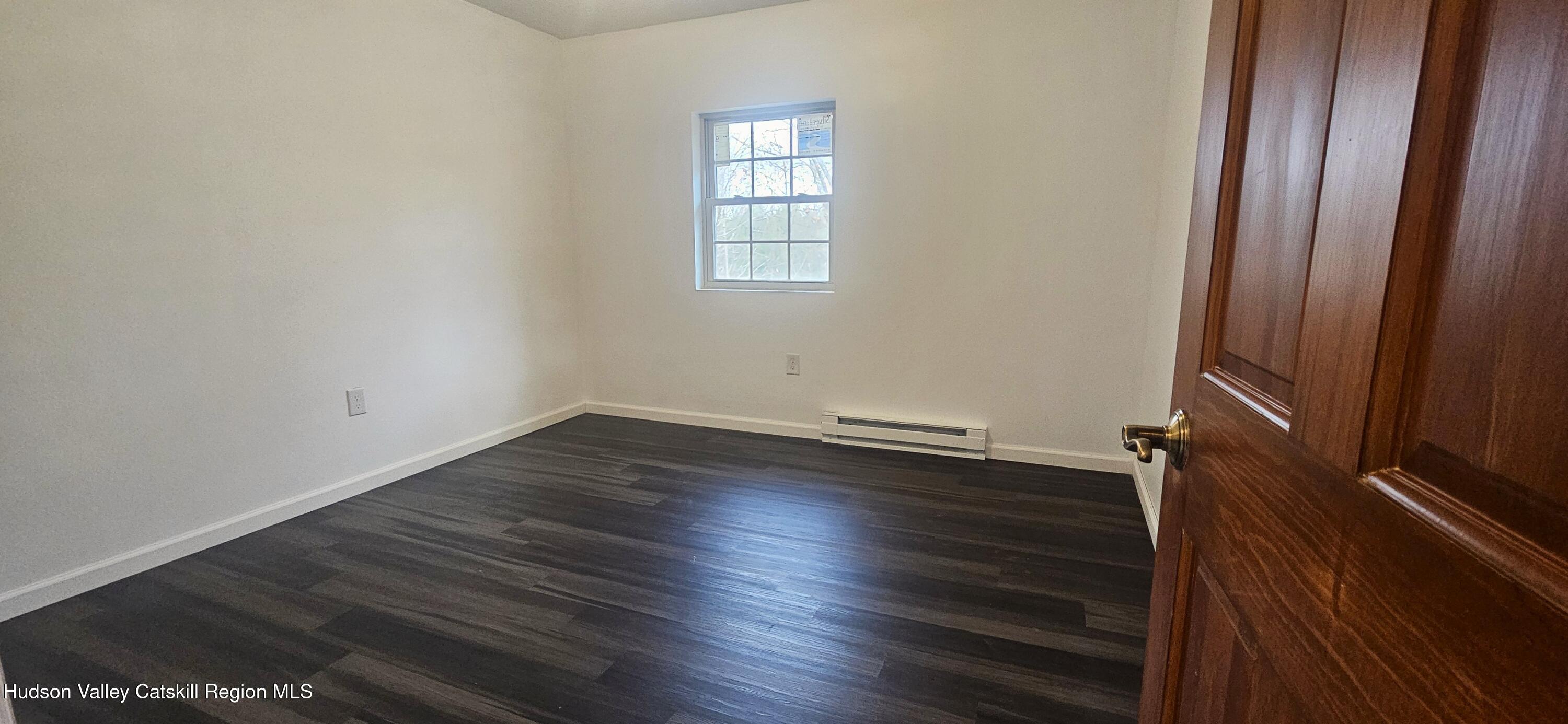 374 North Ridge Road Hannacroix, NY 12087 - Photo 12 of 24 an empty room with wooden floor and windows