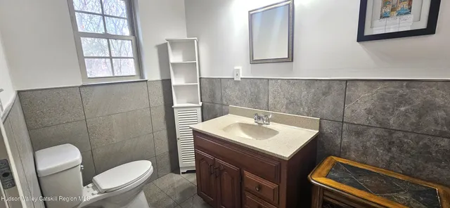 a bathroom with a sink toilet and mirror