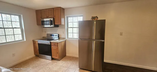 a kitchen with stainless steel appliances granite countertop a refrigerator stove and sink