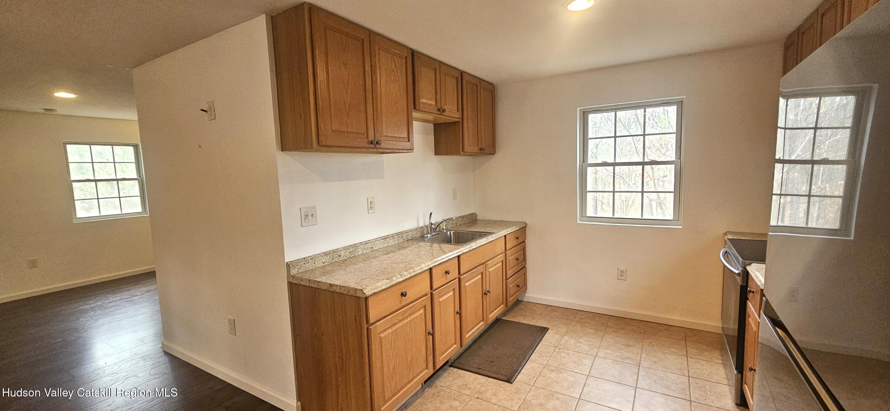 374 North Ridge Road Hannacroix, NY 12087 - Photo 8 of 24 a kitchen with a sink stove and cabinets