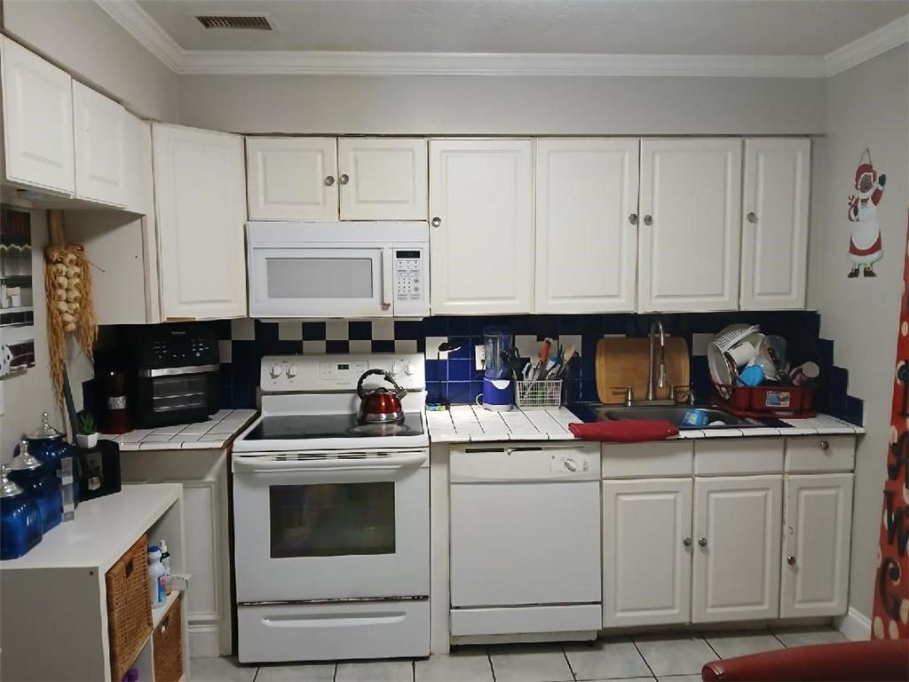 2340 Beaver Ruin Road, Unit UN41 Norcross, GA 30071 - Photo 2 of 12 a kitchen with stainless steel appliances granite countertop a stove a sink and white cabinets