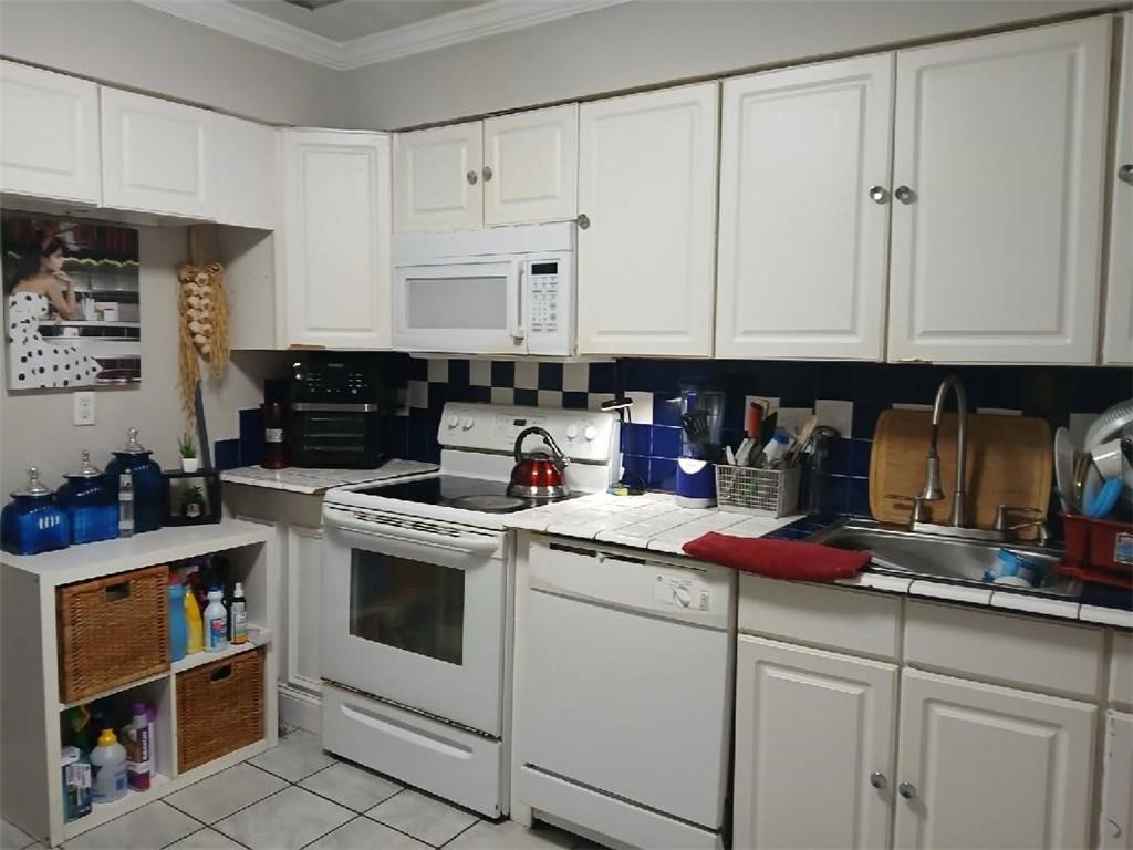 2340 Beaver Ruin Road, Unit UN41 Norcross, GA 30071 - Photo 3 of 12 a kitchen with white cabinets and white appliances