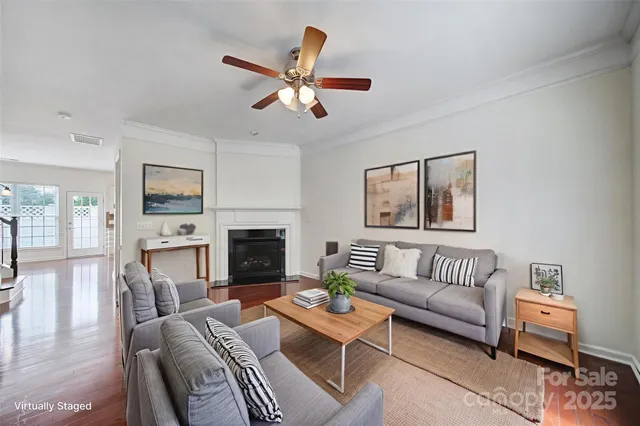 a living room with furniture a fireplace and a flat screen tv