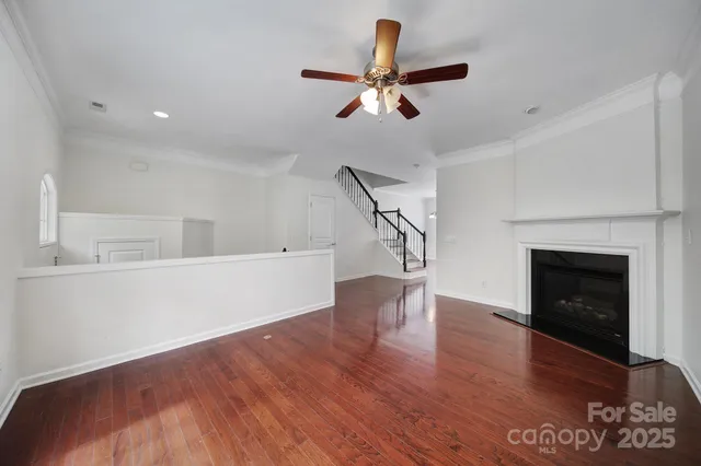 a view of a livingroom with a fireplace and wooden floor