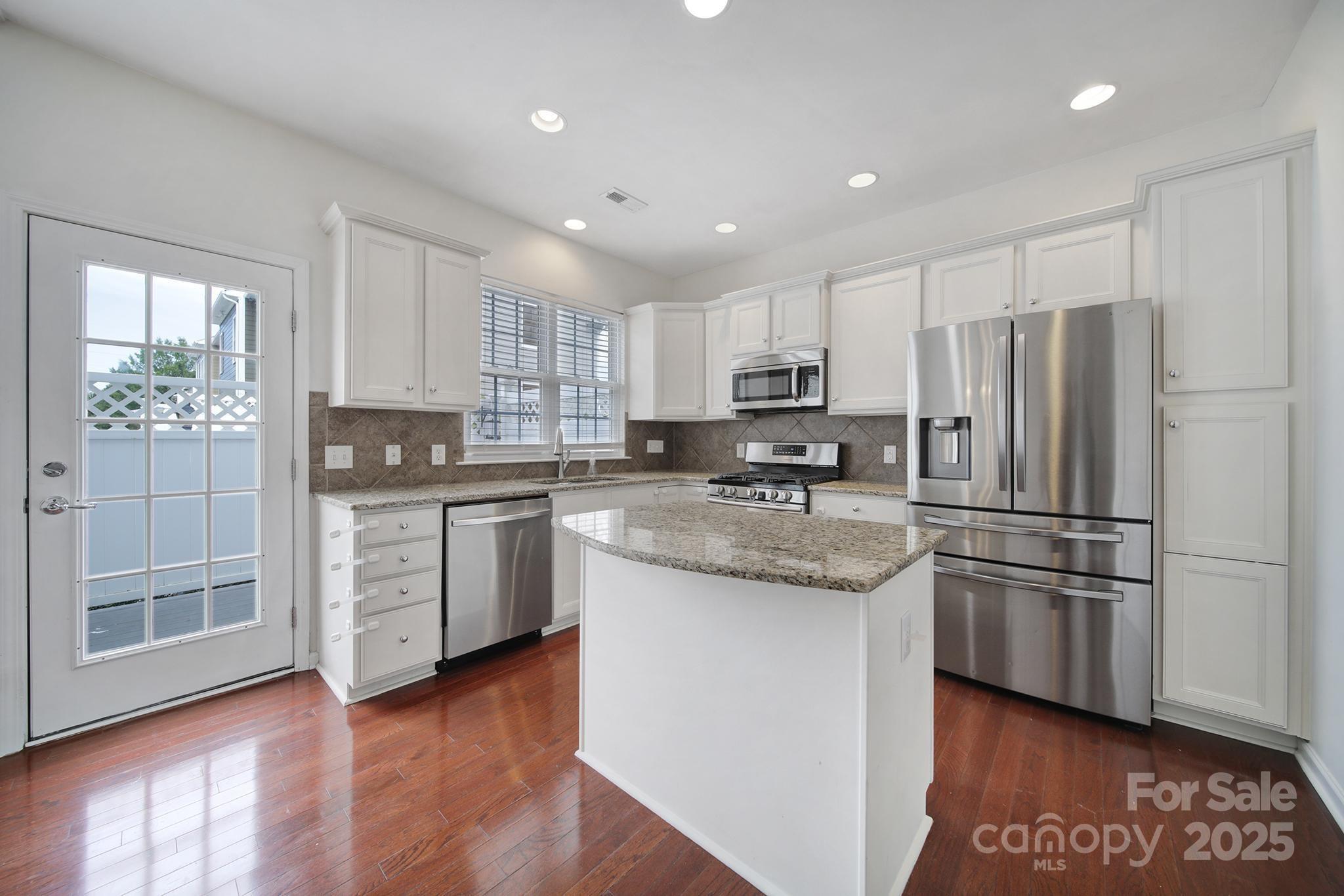 625 6th Baxter Crossing Fort Mill, SC 29708 - Photo 19 of 48 a kitchen with stainless steel appliances granite countertop a refrigerator a stove a sink and a microwave