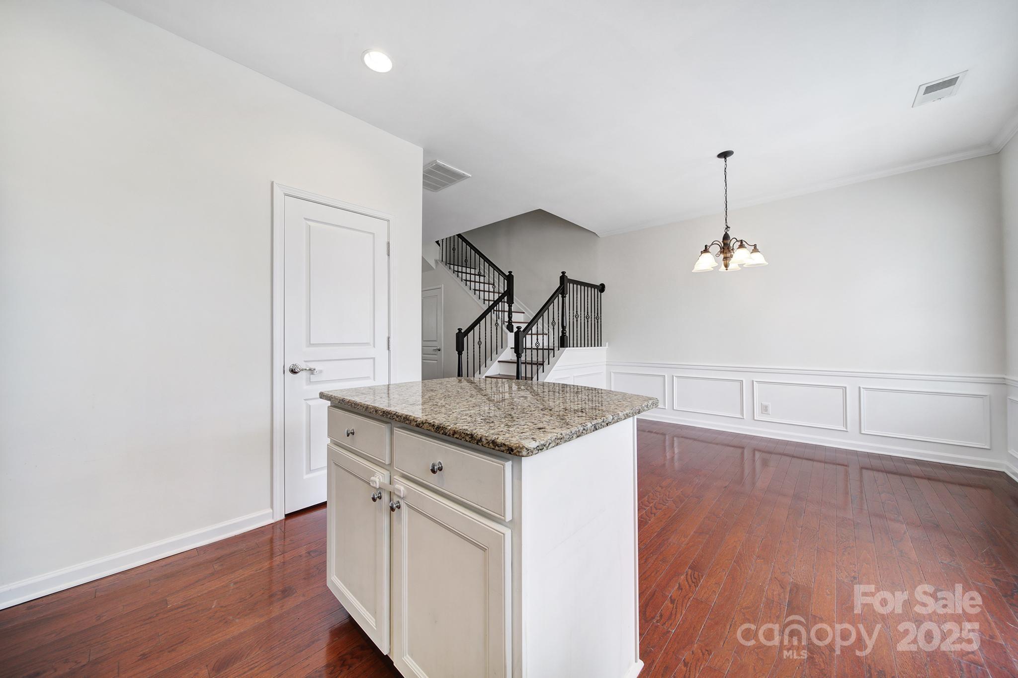 625 6th Baxter Crossing Fort Mill, SC 29708 - Photo 21 of 48 a kitchen with stainless steel appliances granite countertop a sink cabinets and wooden floor