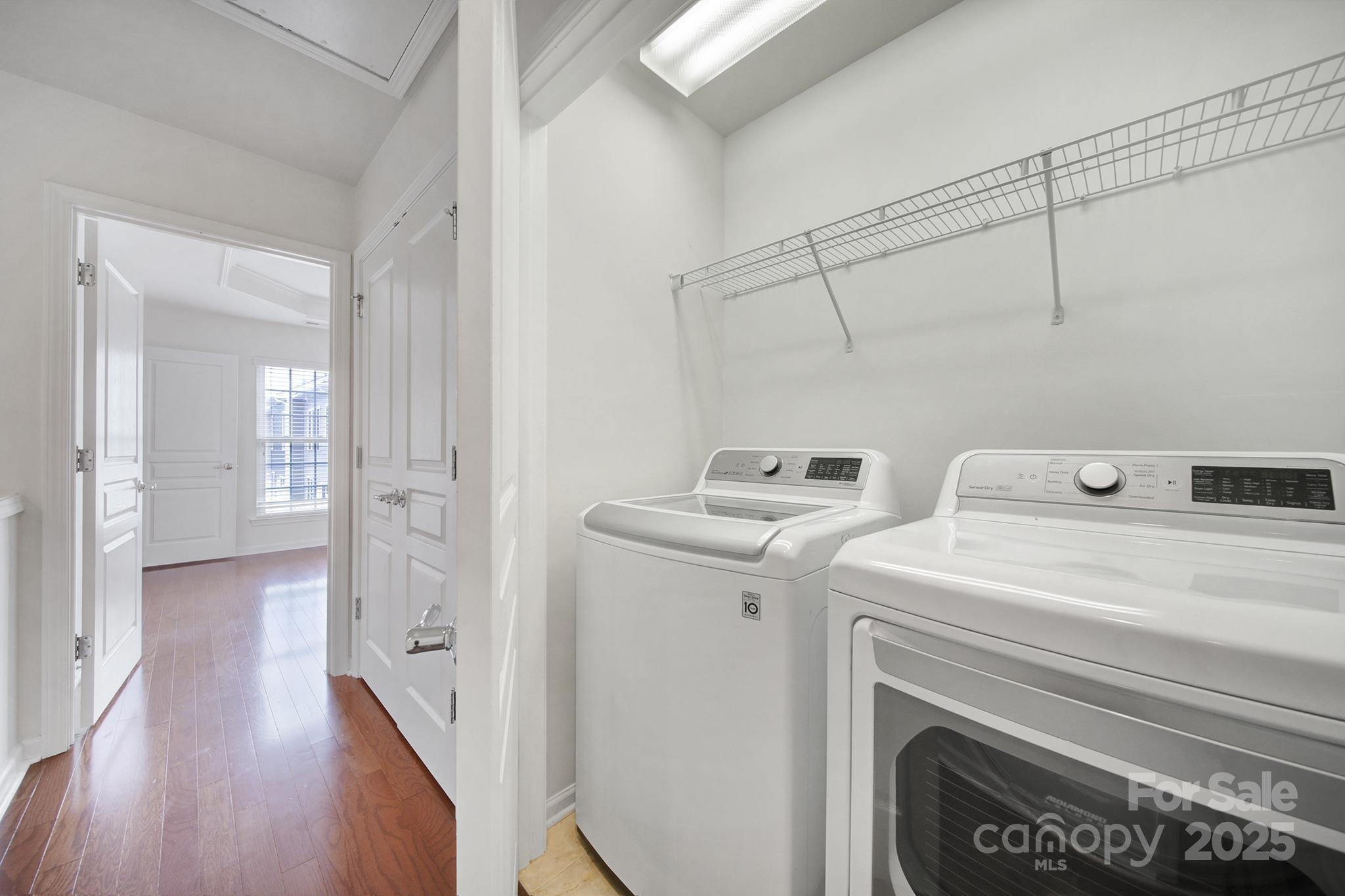 625 6th Baxter Crossing Fort Mill, SC 29708 - Photo 23 of 48 a view of washer and dryer with bathroom in the background