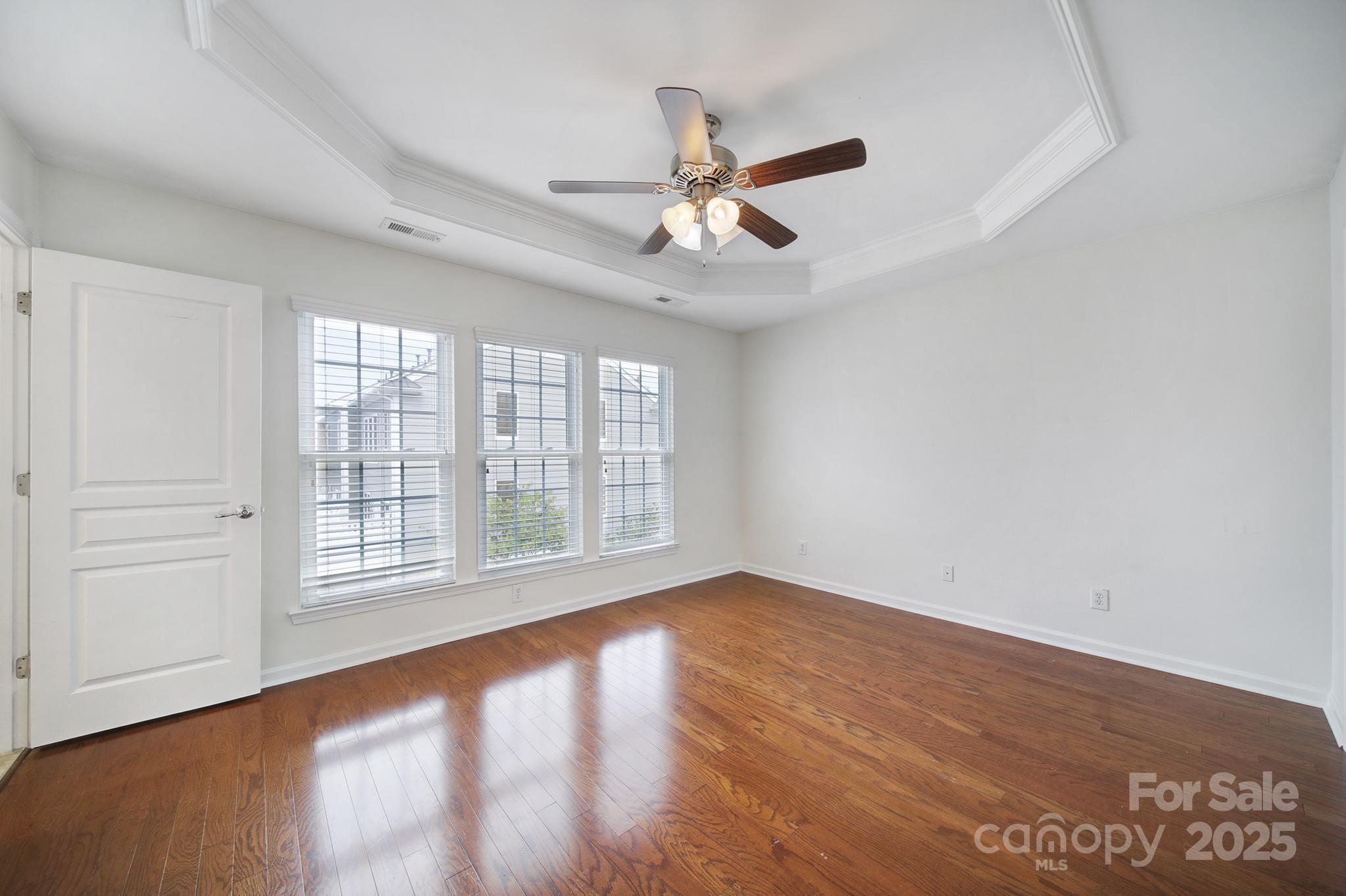 625 6th Baxter Crossing Fort Mill, SC 29708 - Photo 24 of 48 an empty room with wooden floor fan and windows