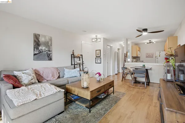a living room with furniture and view of kitchen