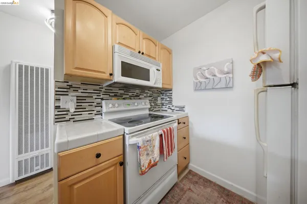 a kitchen with a stove and a microwave