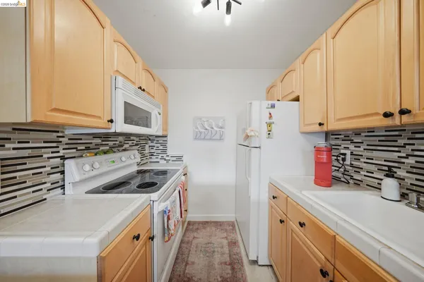 a kitchen with a stove a sink and a refrigerator