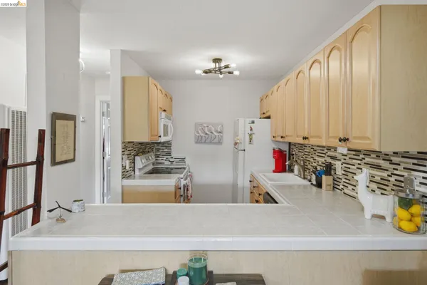 a kitchen with sink refrigerator and microwave