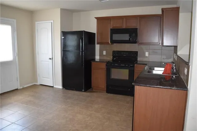 a kitchen with a refrigerator stove and microwave