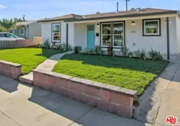 a front view of house with yard and outdoor seating