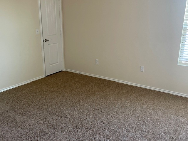 10125 Gertrudis Loop Austin, TX 78747 - Photo 16 of 27 Unfurnished room with dark carpet and baseboards
