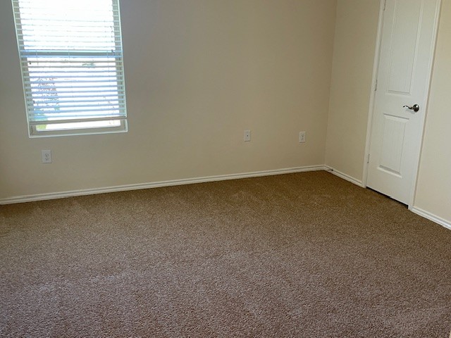 10125 Gertrudis Loop Austin, TX 78747 - Photo 18 of 27 Empty room featuring carpet flooring and baseboards