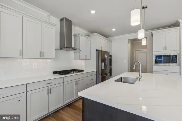 a kitchen with a sink a refrigerator and cabinets