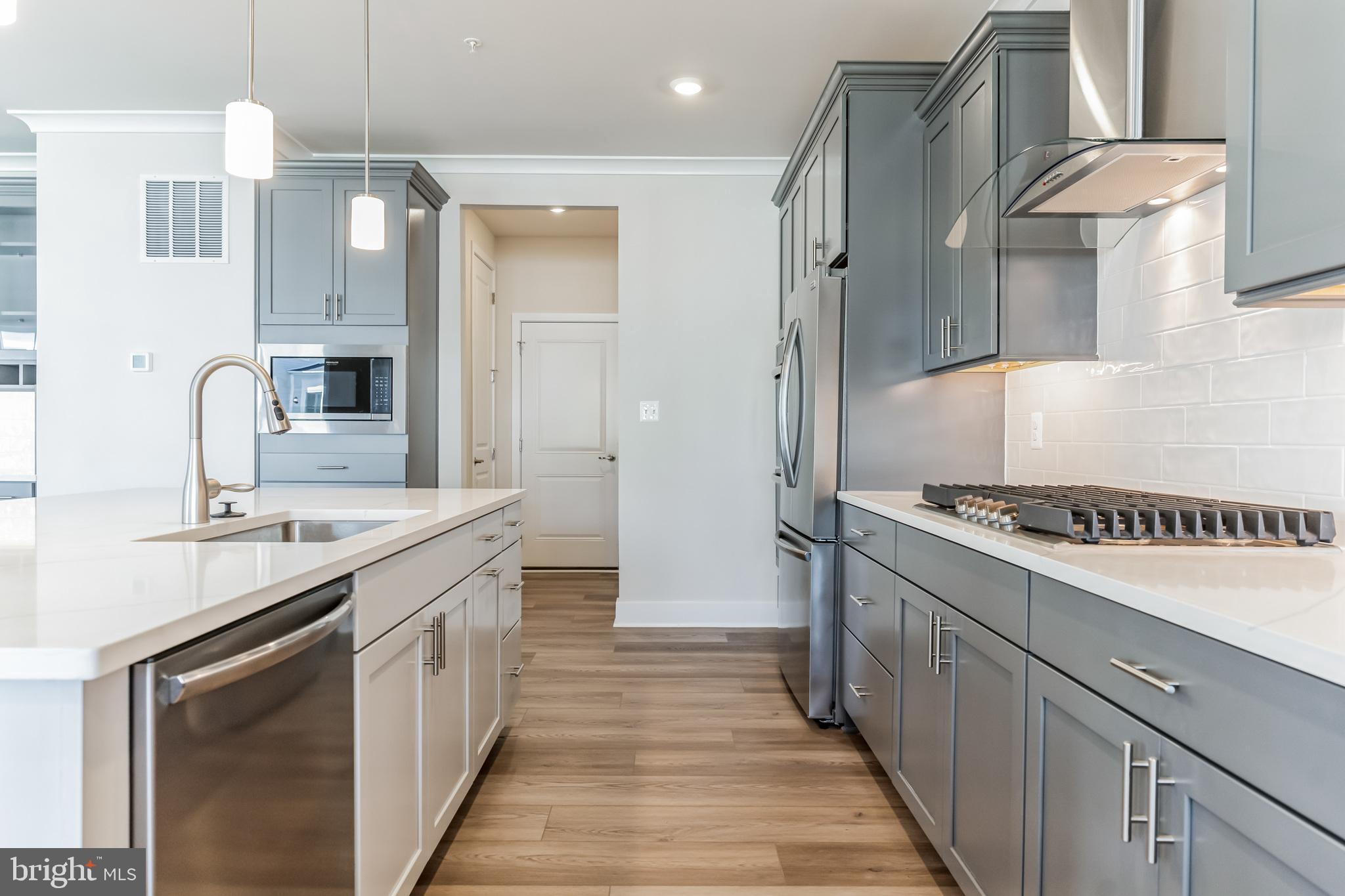 113 Stilly Way Annapolis, MD 21403 - Photo 2 of 13 a kitchen with stainless steel appliances a sink stove and refrigerator
