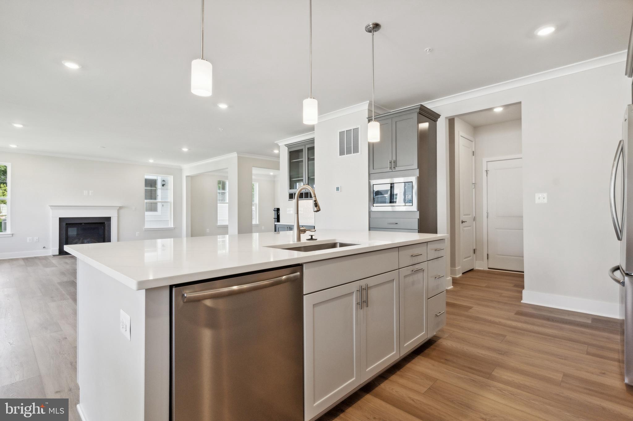 113 Stilly Way Annapolis, MD 21403 - Photo 3 of 13 a kitchen with stainless steel appliances granite countertop a sink a refrigerator and a wooden floor