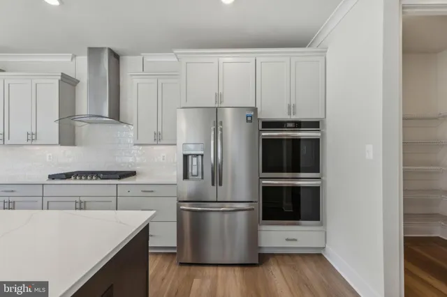 a kitchen with a sink a microwave a stove and refrigerator
