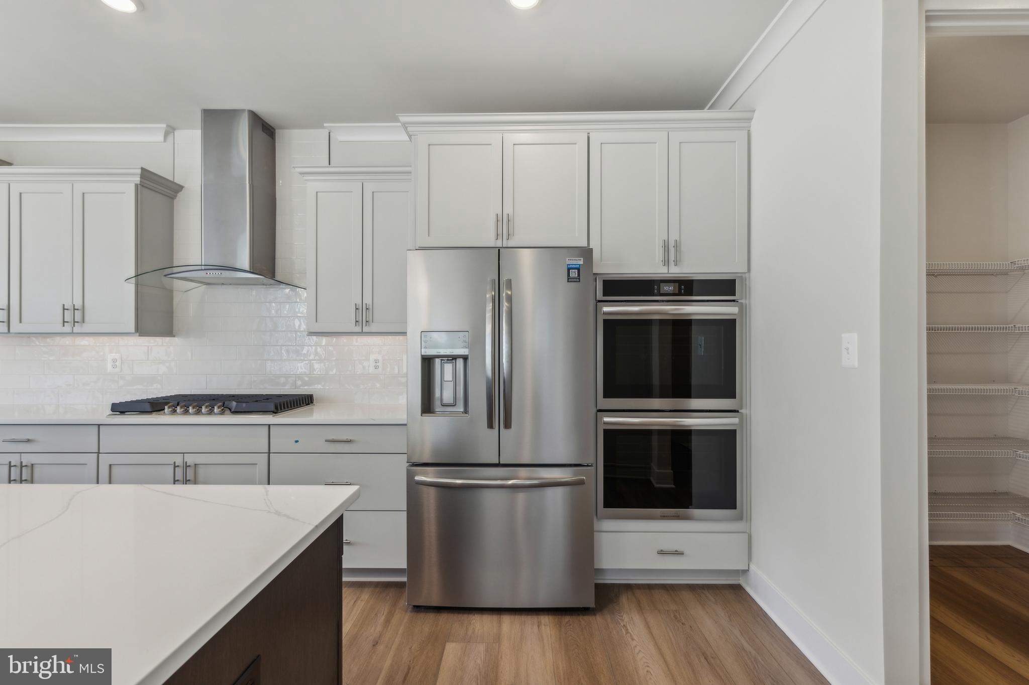 113 Stilly Way Annapolis, MD 21403 - Photo 4 of 13 a kitchen with a sink a microwave a stove and refrigerator