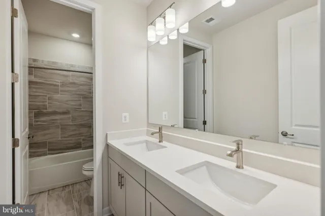 a bathroom with a bathtub shower sink double and mirror