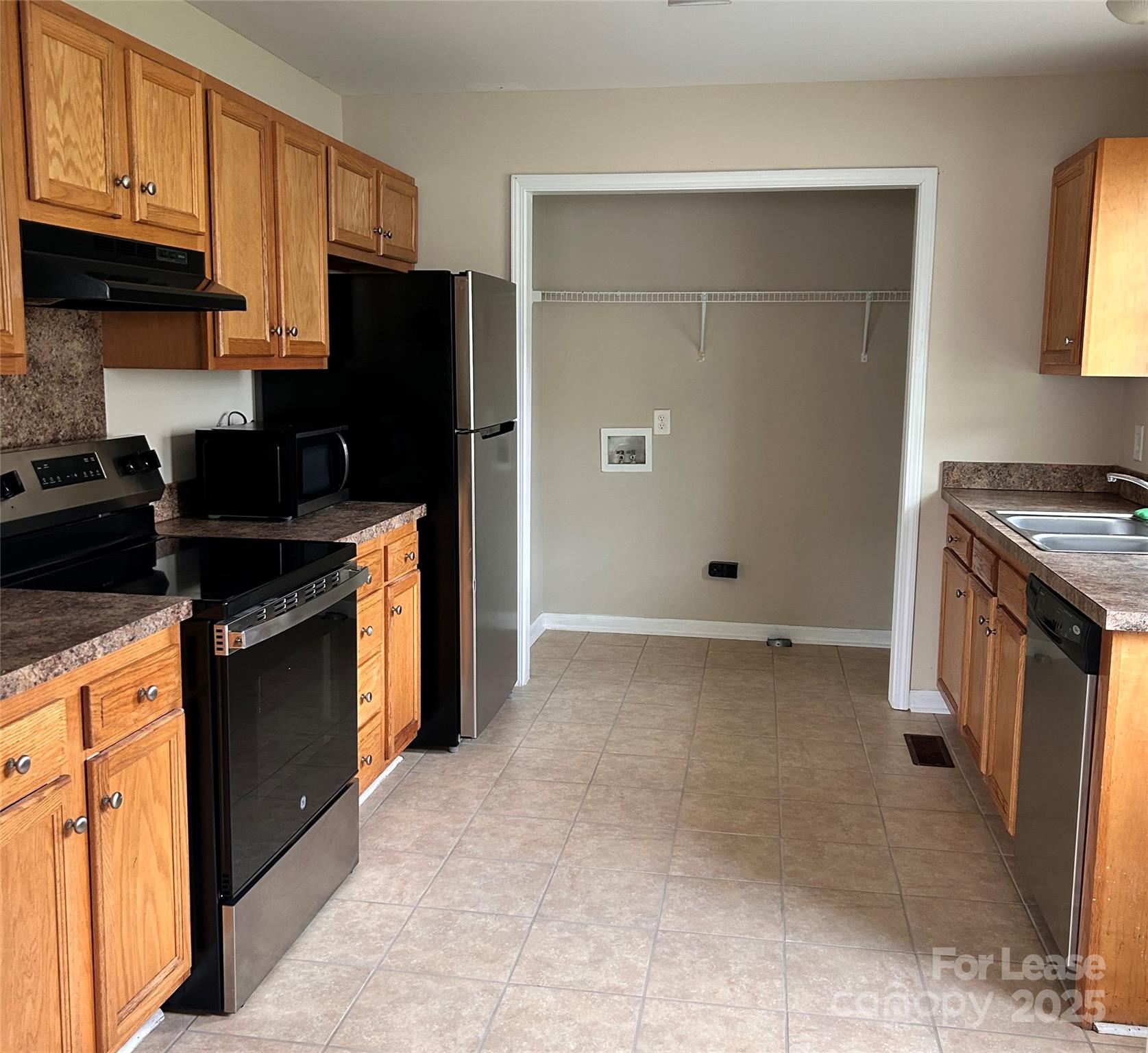 910 Aggie Street Kannapolis, NC 28083 - Photo 3 of 10 a kitchen with stainless steel appliances granite countertop a refrigerator stove and sink