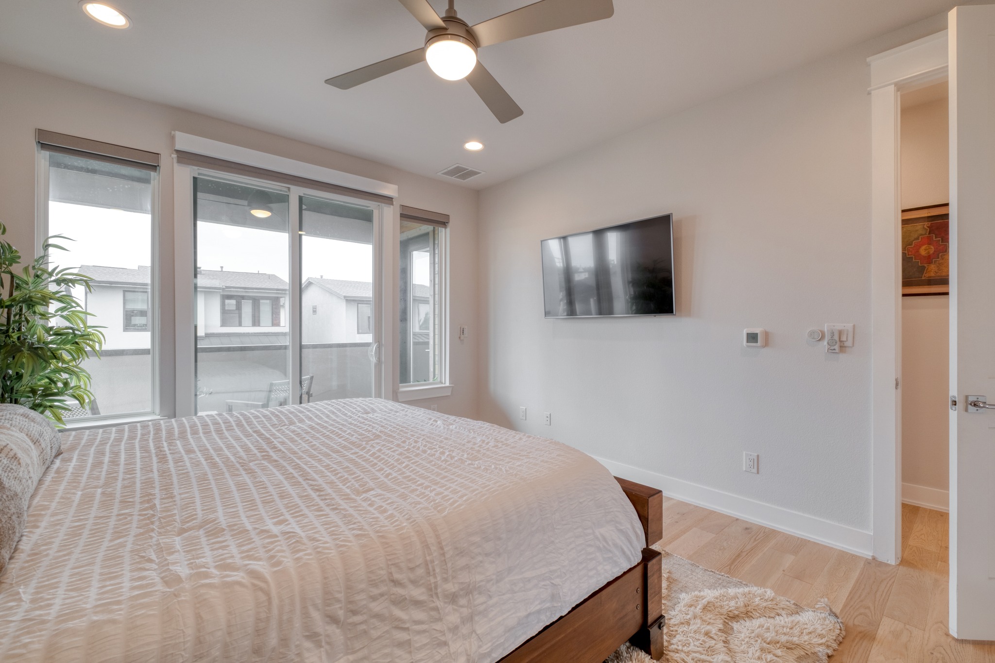 5002 Pecan Springs Road, Unit 7 Austin, TX 78723 - Photo 20 of 34 Large windows and access to a private balcony make this room feel bright and connected to the outdoors