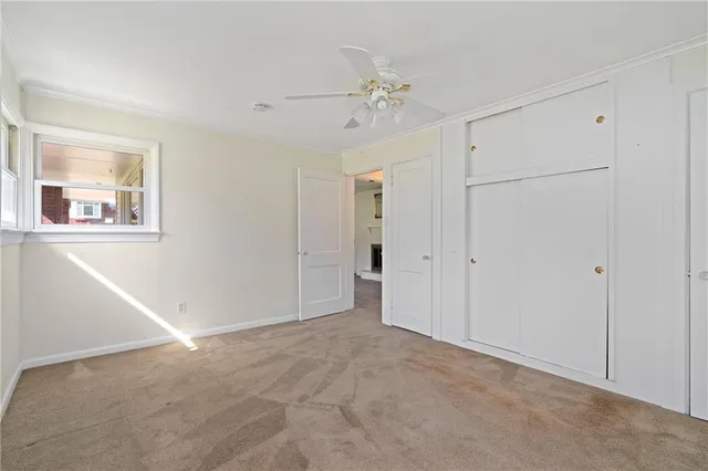 a view of an empty room with a fan