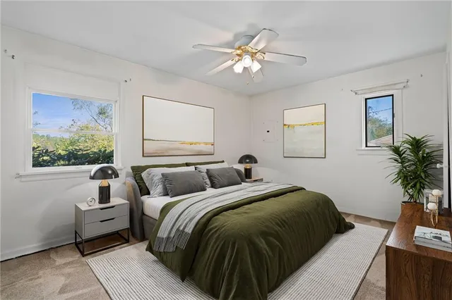 a bedroom with a large bed and a window