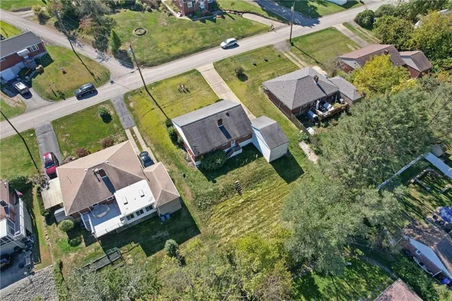 an aerial view of residential house with outdoor space and parking