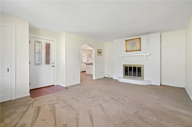 a view of a livingroom with an empty space and a fireplace