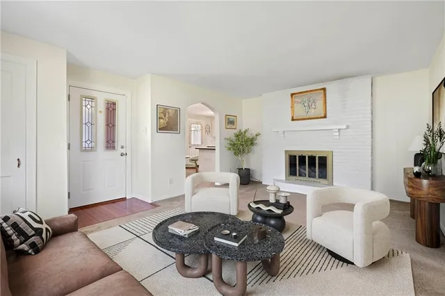 a living room with furniture and a fireplace