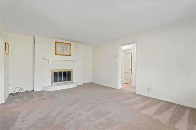 a view of an empty room with a fireplace