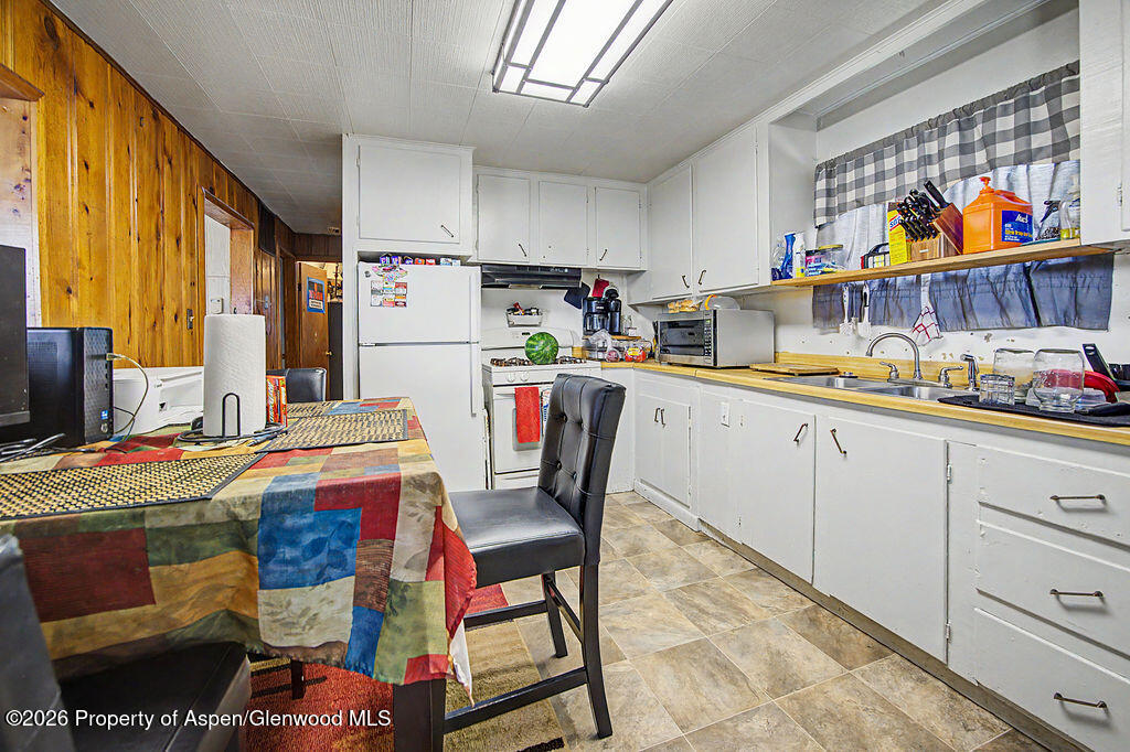 625 Russell Street Craig, CO 81625 - Photo 23 of 35 a utility room with stainless steel appliances a stove a sink and a refrigerator