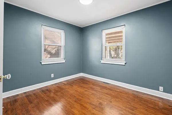 an empty room with windows and closet