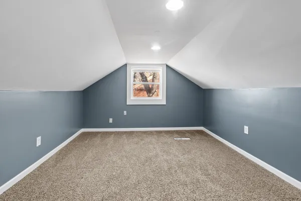 a view of a big room with closet and windows