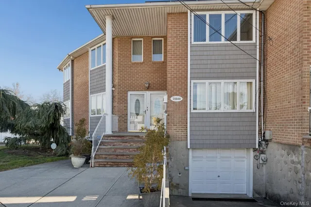 a front view of a house with parking area