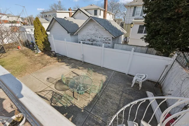 a view of roof house with wooden fence
