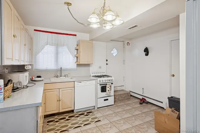 a kitchen with a sink cabinets and appliances