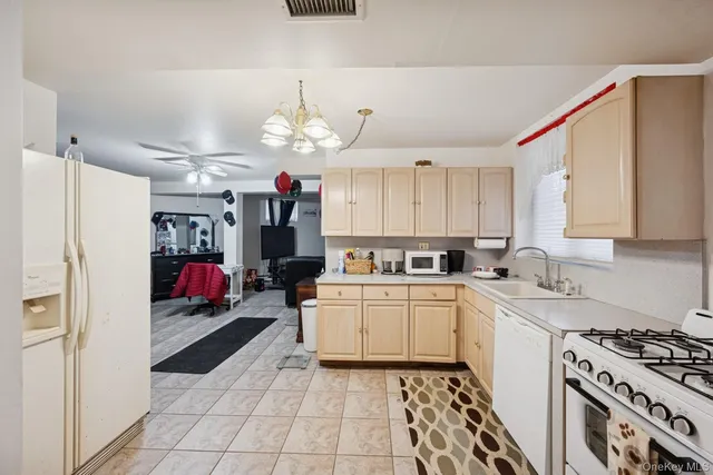 a kitchen that has a lot of white cabinets