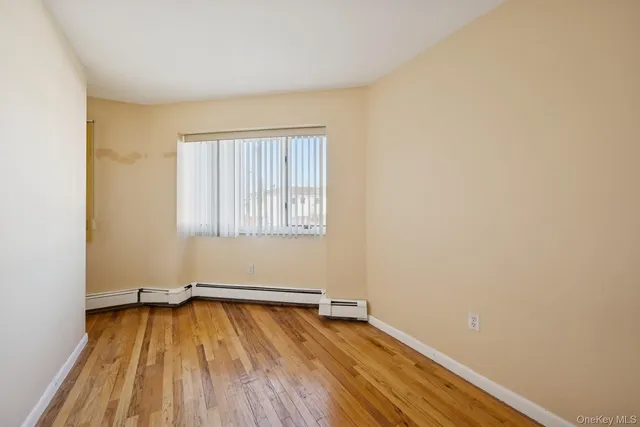 a view of a room with wooden floor and fence