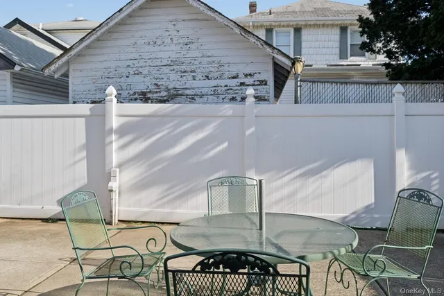 a view of a chairs and table in backyard