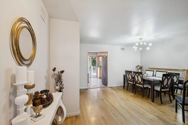 a view of a dining room with furniture and chandelier