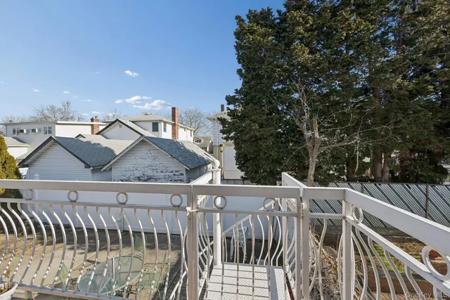 a view of a roof deck with wooden fence and floor
