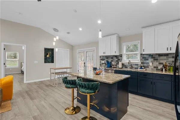 a kitchen with sink cabinets and wooden floor