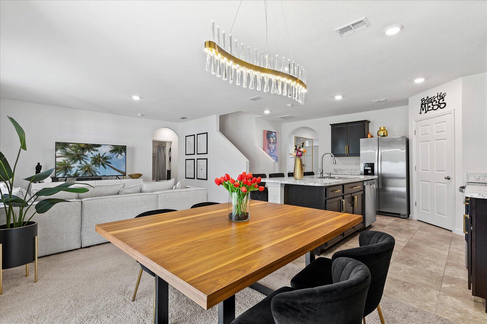 1671 Saxton Road Cocoa, FL 32926 - Photo 11 of 39 a kitchen with stainless steel appliances dining table and chairs