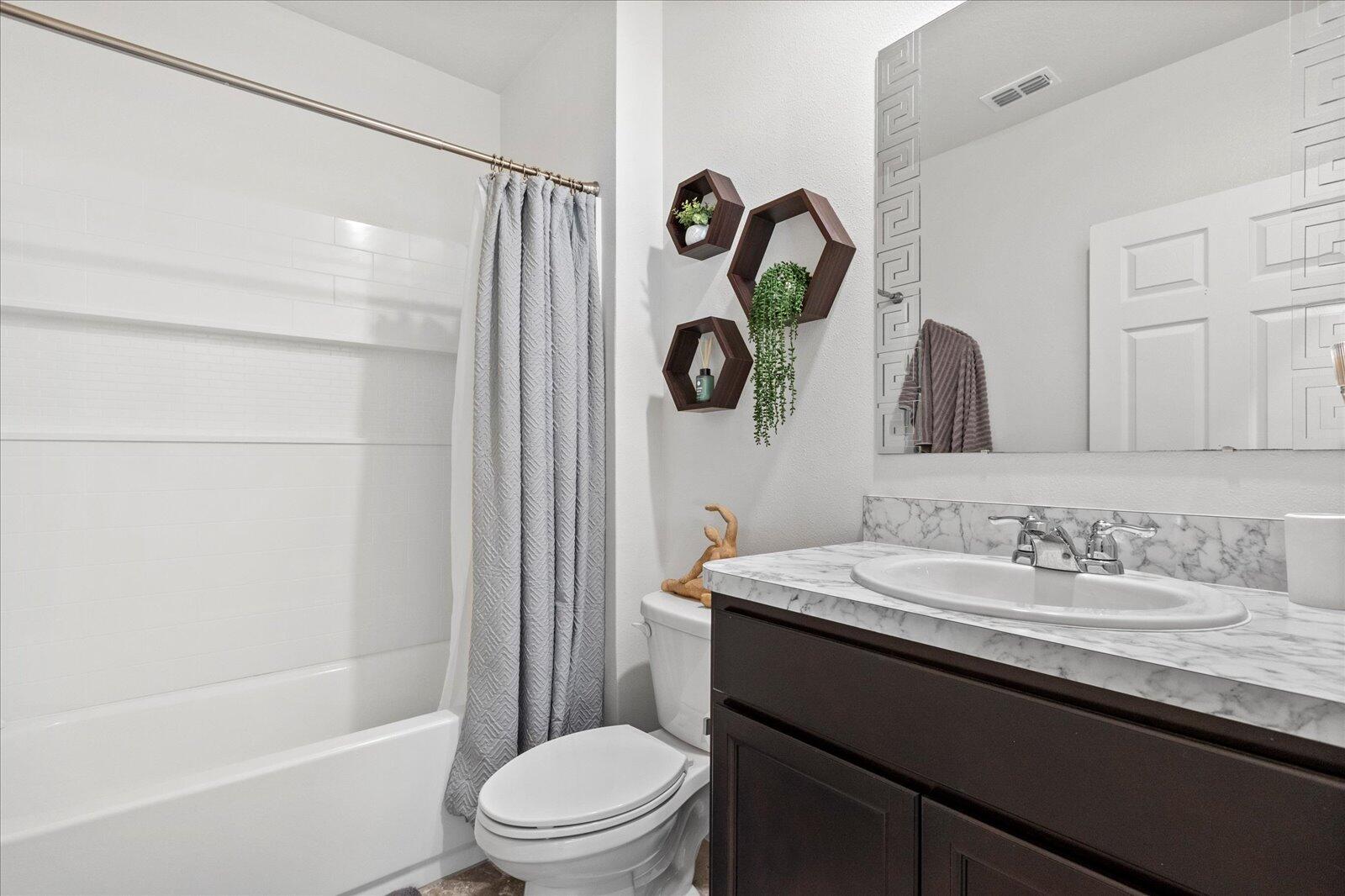 1671 Saxton Road Cocoa, FL 32926 - Photo 15 of 39 a bathroom with a sink a toilet and shower