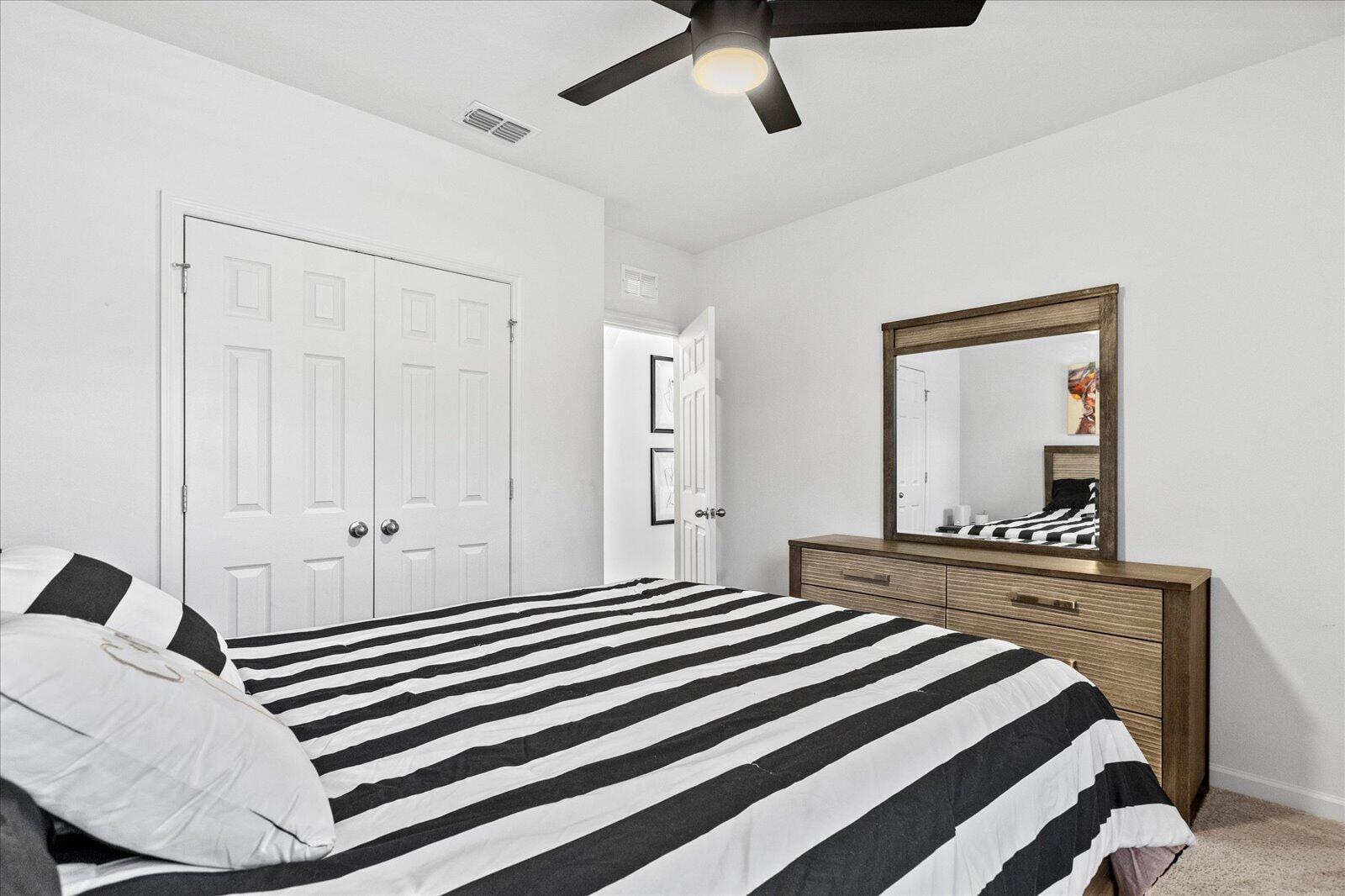 1671 Saxton Road Cocoa, FL 32926 - Photo 17 of 39 a bedroom with a bed and a mirror